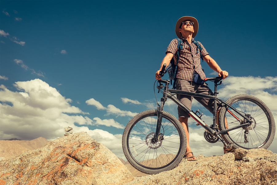 Bikeer traveler with bicycle portrait in Himalayas mountain